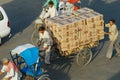 Rickshaw transports boxes with electronics by the street in Jaipur, India.