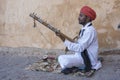 Musician play on traditional music instrument called Kamaycha for tourists on the road in Jaipur, Rajasthan, India Royalty Free Stock Photo