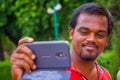 Jaipur, India - September 19, 2017: Portrait of a Indian man holding his cellphone in the hand in Red Fort in Delhi Royalty Free Stock Photo