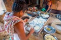 Jaipur, India - September 20, 2017: Two unidentified men cooking Indian food over a wooden table with some material next