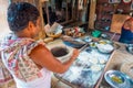 Jaipur, India - September 20, 2017: Two unidentified men cooking Indian food over a wooden table with some material next