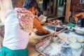 Jaipur, India - September 20, 2017: Two unidentified men cooking Indian food over a wooden table with some material next