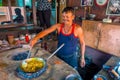 Jaipur, India - September 20, 2017: Unidentified man cooking Indian food in a metallic tray over incandescent rocks in