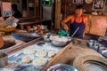 Jaipur, India - September 20, 2017: Unidentified man cooking Indian food over a wooden table with some material next to