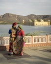 Couple in beautiful clothes posing at Jal Mahal Palace in Jaipur India Royalty Free Stock Photo