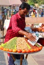 Man selling spices nuts and vegetables