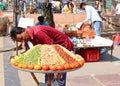 Man selling spices nuts and vegetables