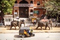 Painted elephants for the Holi Elephant festival riding through the busy traffic with bikes of the city in Jaipur, Rajasthan, Royalty Free Stock Photo