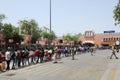 Long queue of Indian migrant laborers outside the railway station waiting to leave the city due to covid-19 pandemic.