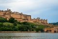 Jaipur, Rajasthan, India, September 7, 2020 : Intricately carved gateway Amer Fort Palace with maota lake and clouds in sky Royalty Free Stock Photo