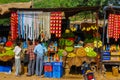 Jaisalmer, India - August 20, 2009: greengrocer on the road with group of Indians making purchases