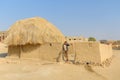 Indian boy near traditional house in village at Thar desert. Jaisalmer. India Royalty Free Stock Photo