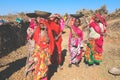 Women colourful sari working on road