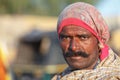 Traditionally dressed unidentified Indian tribal man looks at the camera with a strong character in his face, Jaisalmer, India Royalty Free Stock Photo