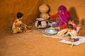 Rural women cooking in her house and feeding her children, poor family concept