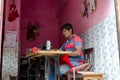 Middle age tailor sewing at his shop