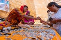 Jaisalmer, Rajasthan, India - October 13, 2019 : Rajasthani women selling and negotiating price of jewelleries with female tourist