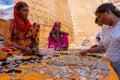 Rajasthani women selling and negotiating price of jewelleries with female tourist