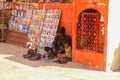 Shoemaker with his child setting at the street of Jaisalmer