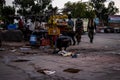 Man picking up waste from an open sewerage in the market