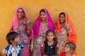 Smiling and happy Rajasthani women and children in local costume, posing in a Rajasthani village