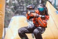 Professional female paintball players in a speedball field