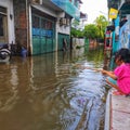 Jakarta flood kid with the stick toys to fill boring situation