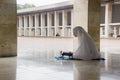 Asian woman reading Quran in the Istiqlal mosque Royalty Free Stock Photo