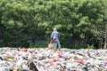 Dustman loading plastic waste into a bag