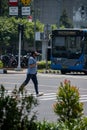 Jakarta, Indonesia - August 26, 2020: Portrait of man running at zebra cross.