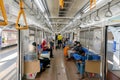 View inside the Jakarta commuter line train carriage. Passengers sitting in a train carriage