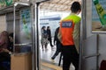 Commuter line security officer in train carriage, standing in front of the train door