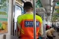 Commuter line security officer in train carriage, standing in front of the train door