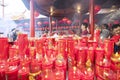 People burning incensed stick in temple