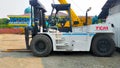 Jakarta, Indonesia - July 18, 2022: Side view large 23 Tons FD230 capacity TCM forklift parking at the yard