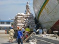 Jakarta, Indonesia - July 13, 2009: unskilled workers having a break from loading sacks from a truck onto a wooden transport