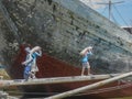 Jakarta, Indonesia - July 13, 2009: unskilled workers loading sacks with cement onto a wooden transport vessel