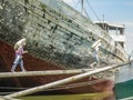 Jakarta, Indonesia - July 13, 2009: unskilled workers loading sacks with cement onto a wooden transport vessel