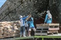 Jakarta, Indonesia - July 13, 2009: unskilled workers loading sacks from a truck onto a wooden transport vessel