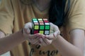 hand holding a Rubik\'s cube.