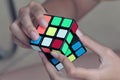 hand holding a Rubik\'s cube.