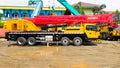 Jakarta, Indonesia - June 14, 2022: 55 ton yellow truck crane with red boom