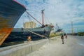 JAKARTA, INDONESIA - 5 MARCH, 2017: Inside famous old port area of Jakarta, fishing boats lying at harbor, fishermen