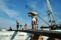 Laborers are transporting cement from trucks to ships at Sunda Kelapa Harbor, Jakarta - Indonesia