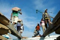 Laborers are transporting cement from trucks to ships at Sunda Kelapa Harbor, Jakarta - Indonesia
