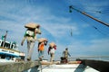 Laborers are transporting cement from trucks to ships at Sunda Kelapa Harbor, Jakarta - Indonesia