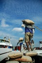 Laborers are transporting cement from trucks to ships at Sunda Kelapa Harbor, Jakarta - Indonesia