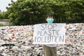 Male teenager shows a text of stop plastic pollution