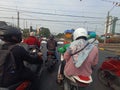 Jakarta , Indonesia - October 31, 2023: A group of people riding motorbikes, stops at a railroad crossing, in Jakarta, Indonesia