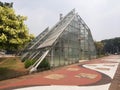 Jakarta, Indonesia September 10-2023: The iconic greenhouse building in Menteng Park is a characteristic view of the park